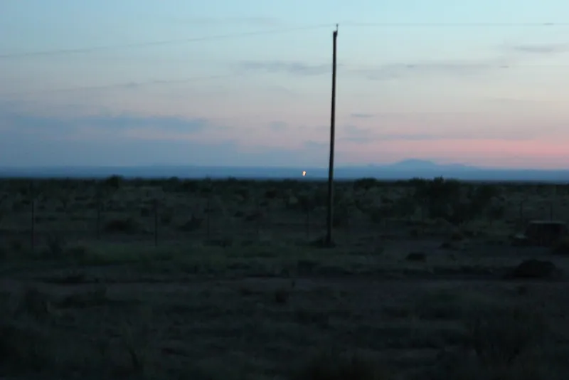 A light on the horizon at dusk over Mitchell Flat