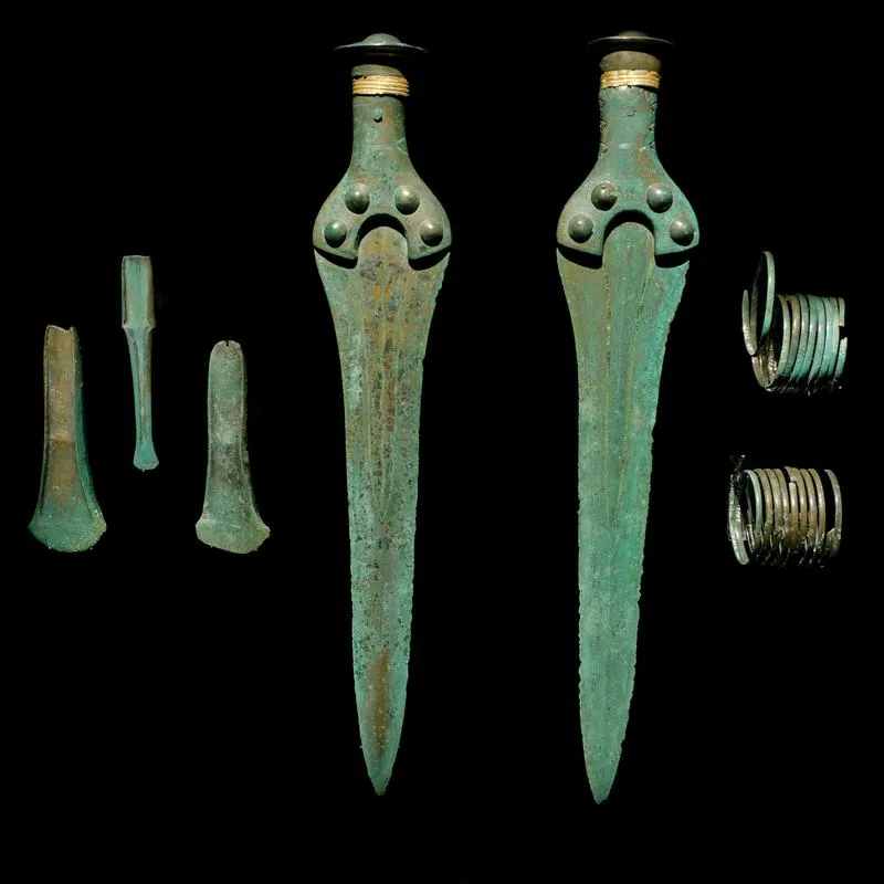 Two flanged axes, a chisel (HK 2002:1649 b) and two spiral arm rings: photo