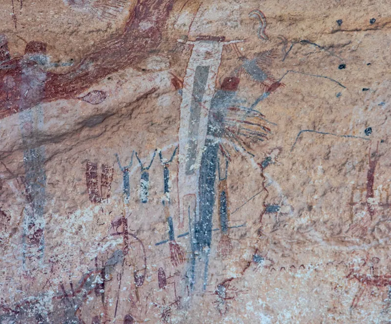 The White Shaman mural: detail of the white figure and the black figures