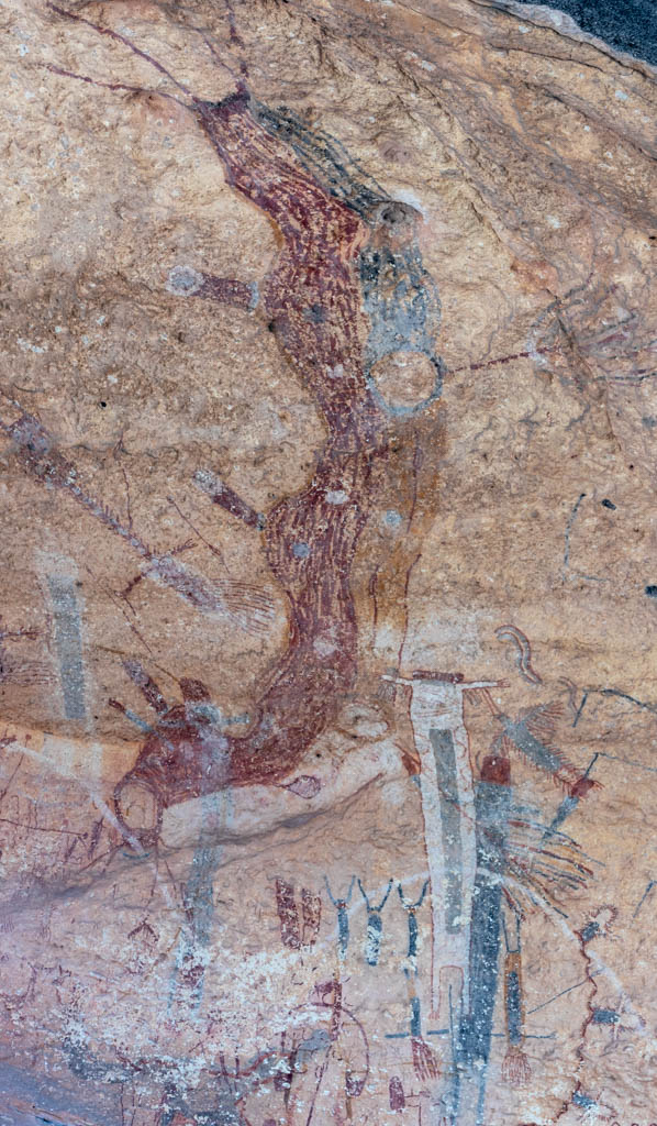 The long red and black undulating band that curves down the centre of the panel to the white figure, with a figure carrying a ring near its upper end. Which of Boyd's identifications it corresponds to is not stated by the photographer.